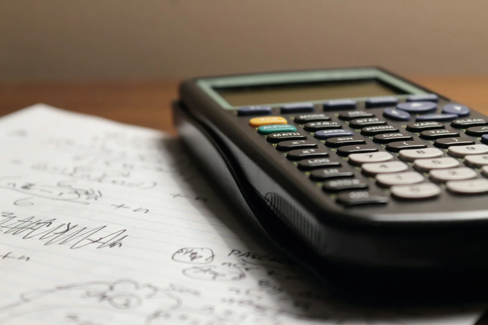 A calculator on handwritten notes for budget planning