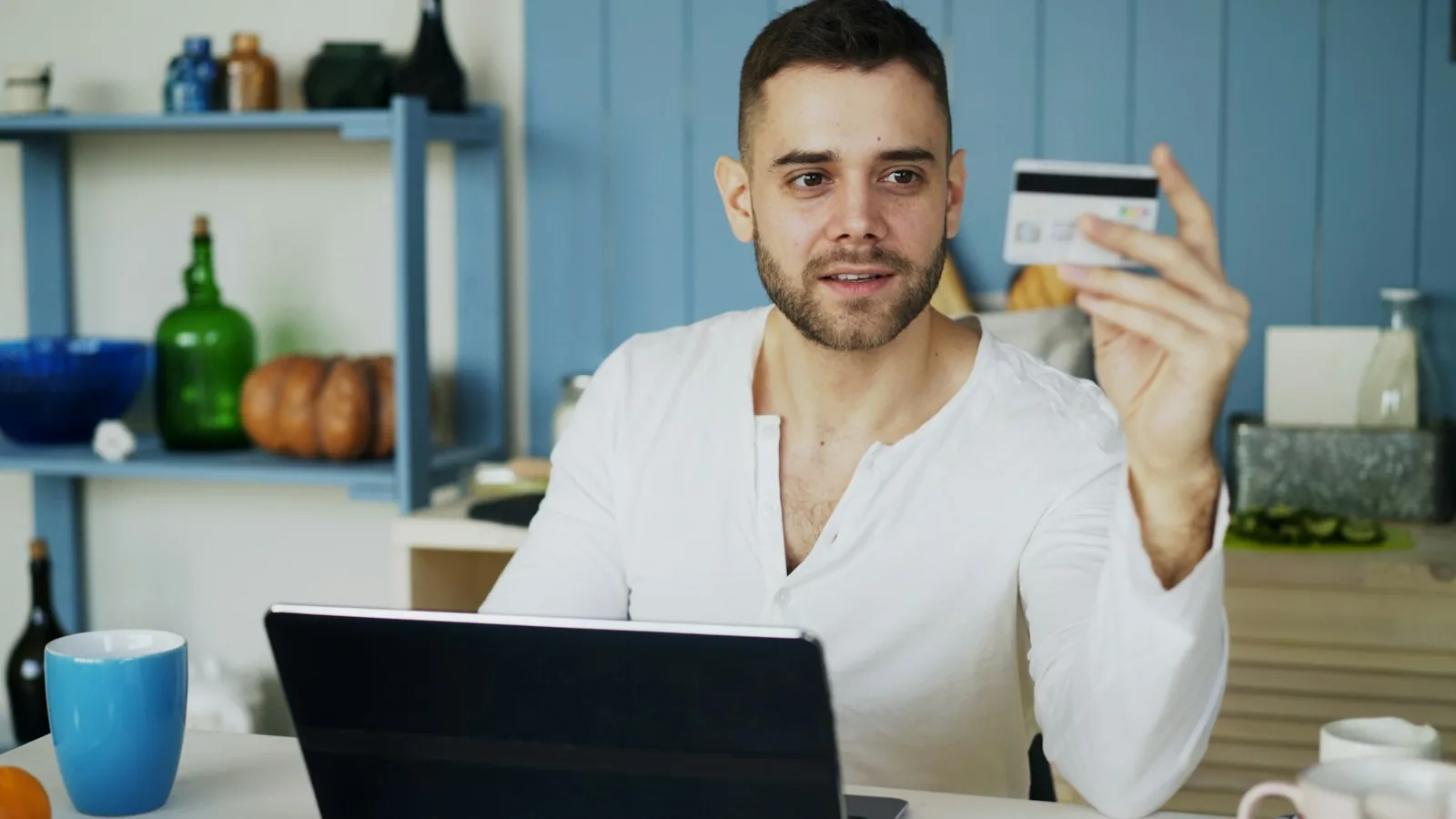 A customer using a laptop and credit card to shop online