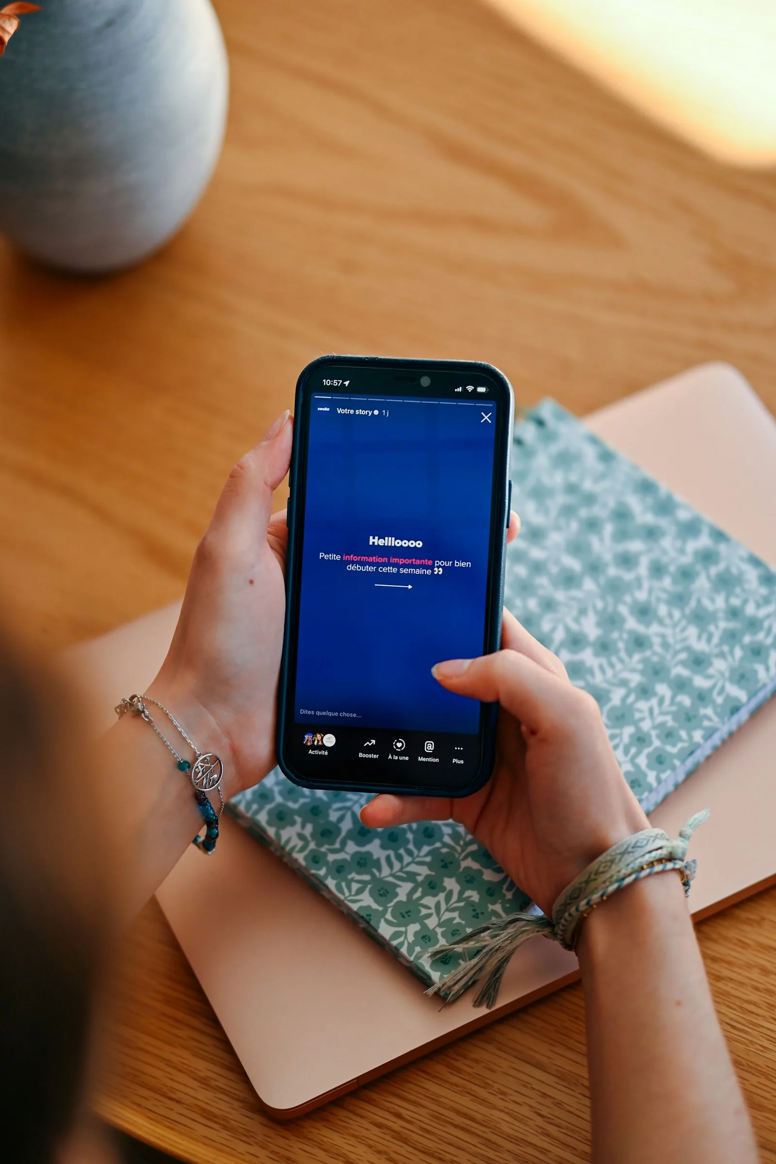 Hands holding a smartphone displaying a social media feed